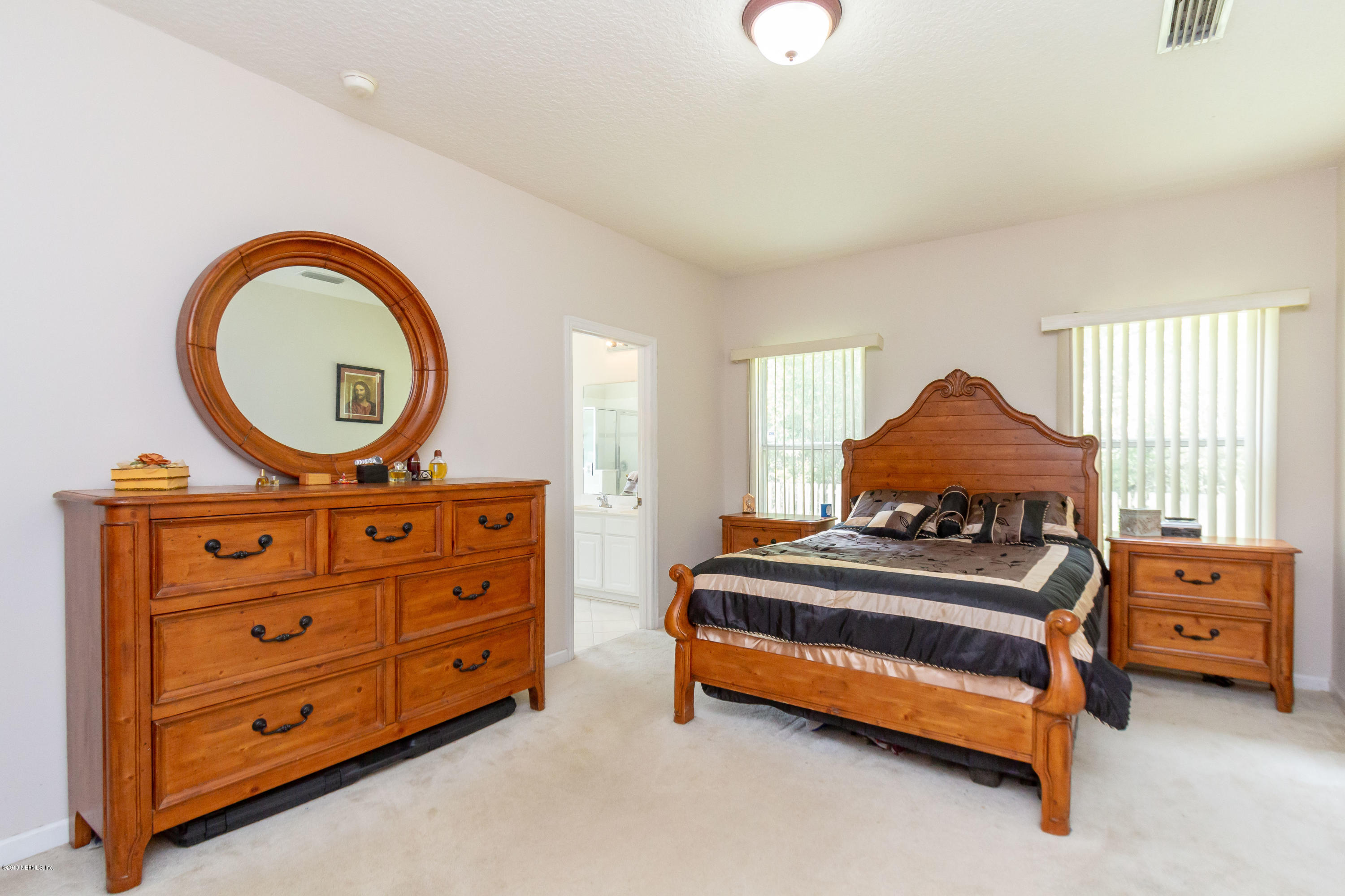 321 Stonehurst Parkway St. Augustine, FL 32092 - Photo 26 of 60 a bedroom with a bed and a dresser