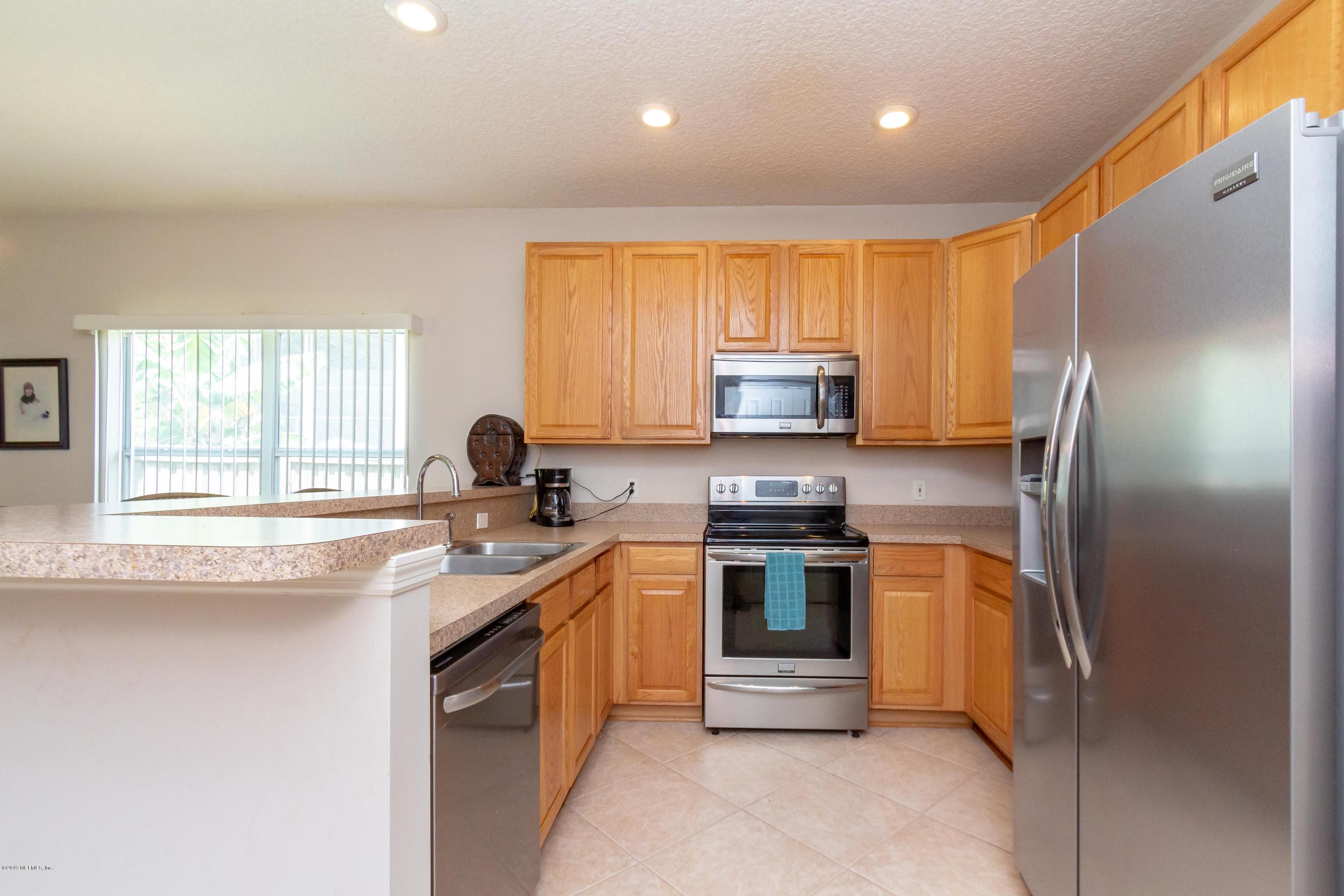 321 Stonehurst Parkway St. Augustine, FL 32092 - Photo 3 of 60 a kitchen with stainless steel appliances granite countertop a stove a sink dishwasher a refrigerator and a microwave