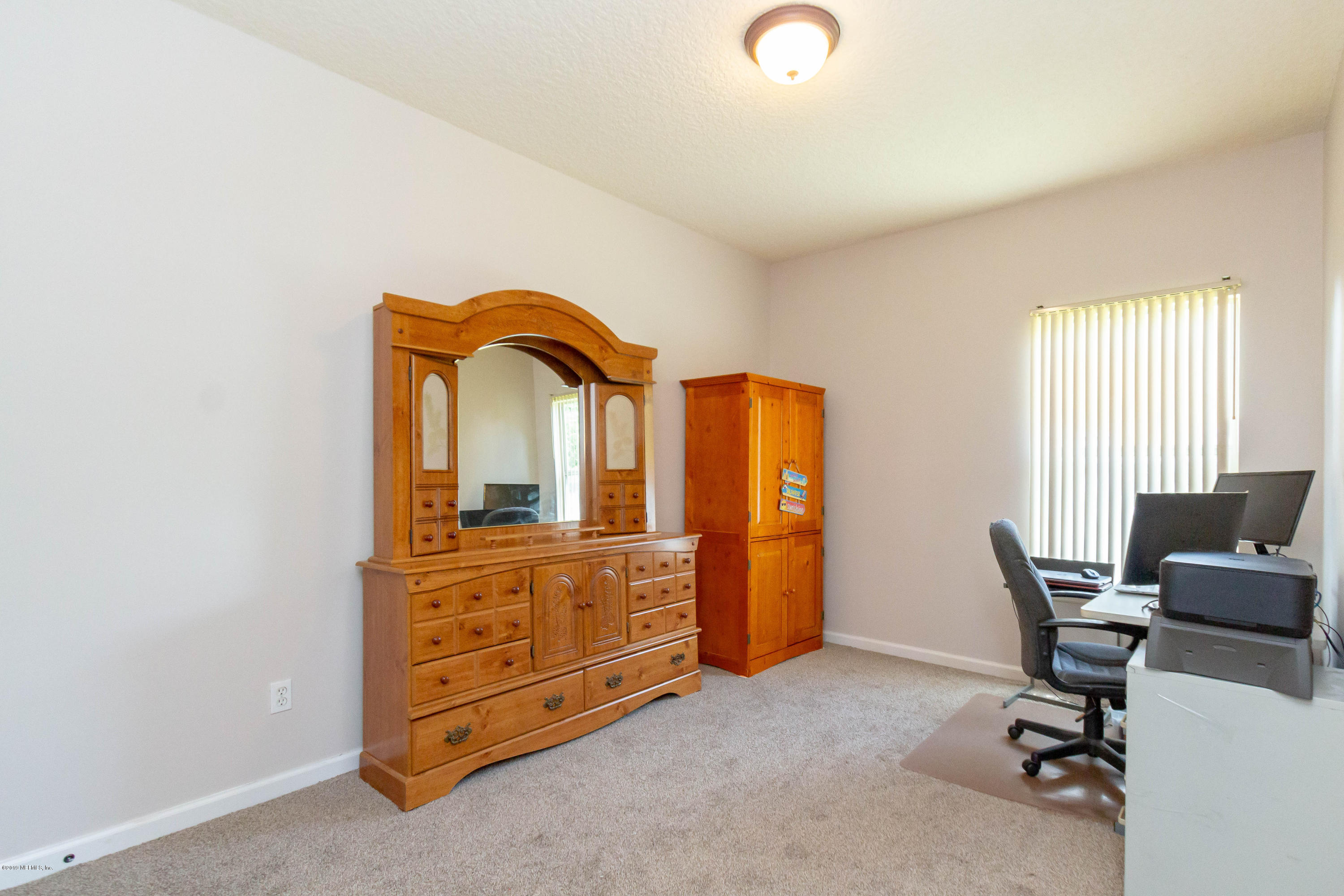 321 Stonehurst Parkway St. Augustine, FL 32092 - Photo 35 of 60 a view of a workspace with furniture and a window