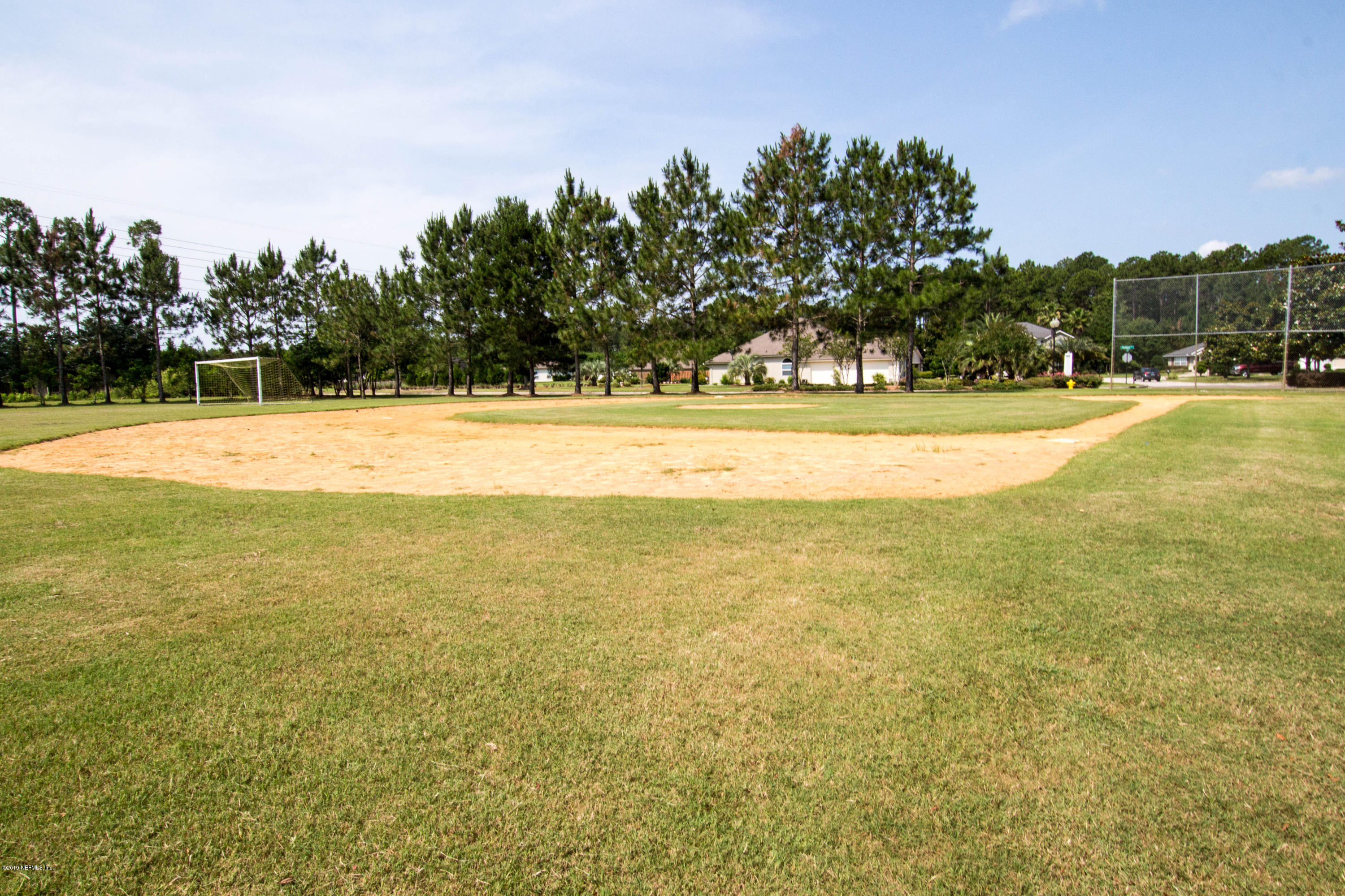 321 Stonehurst Parkway St. Augustine, FL 32092 - Photo 50 of 60 a view of an swimming pool and trees in the background