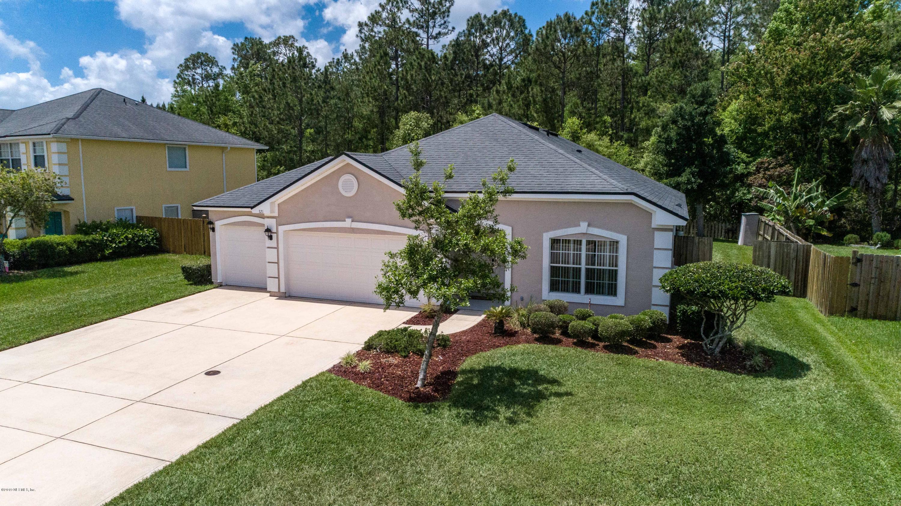 321 Stonehurst Parkway St. Augustine, FL 32092 - Photo 57 of 60 a front view of a house with a yard and garage
