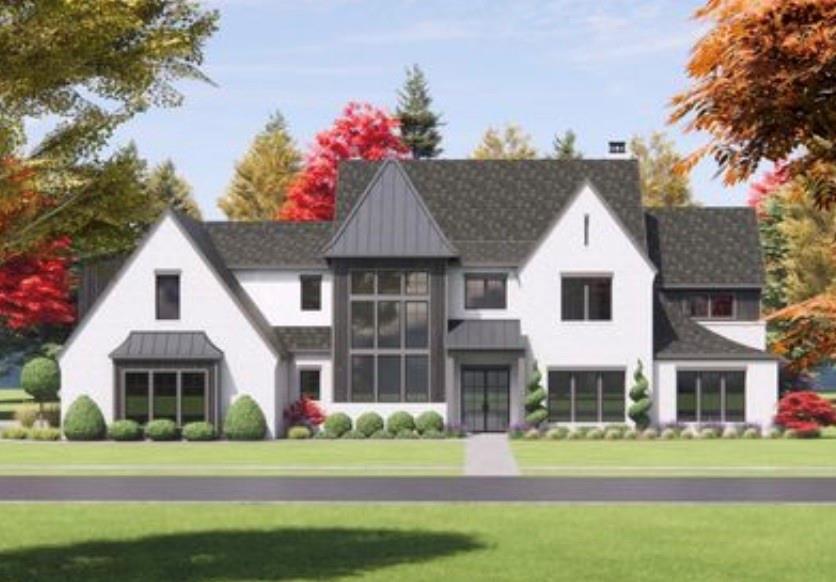 a view of a white house with a yard and potted plants