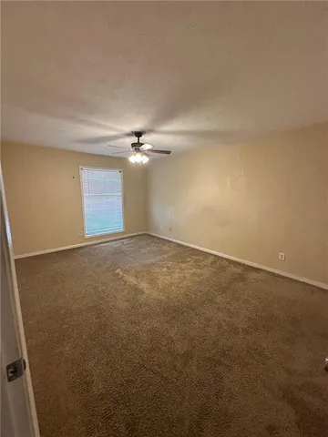 an empty room with a empty space and windows