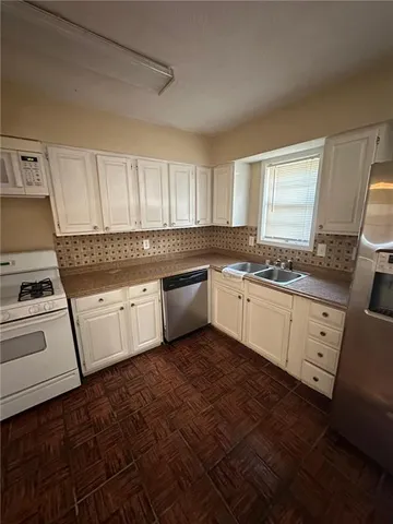 a kitchen with a stove a sink and a microwave