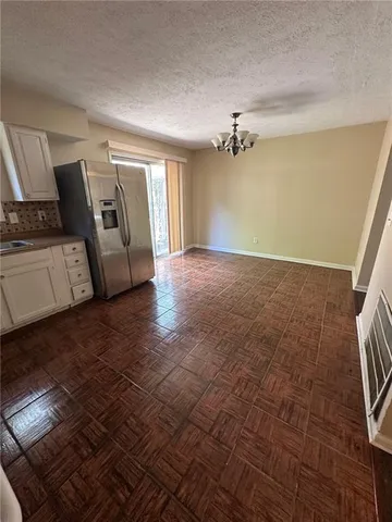 a view of a livingroom with an empty space and a stove