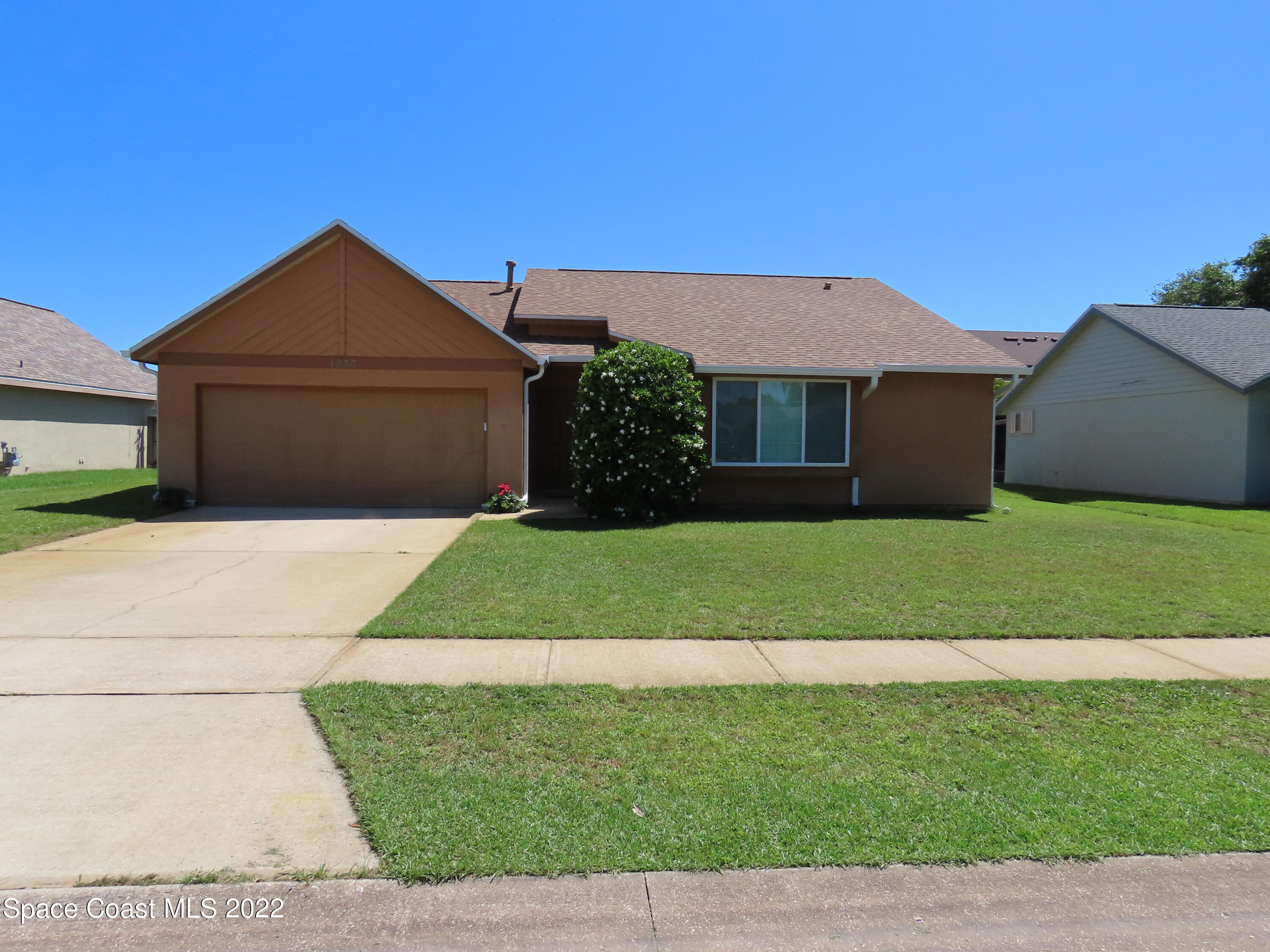 1233 Walnut Grove Way Rockledge, FL 32955 - Photo 1 of 19 a front view of a house with a yard and garage