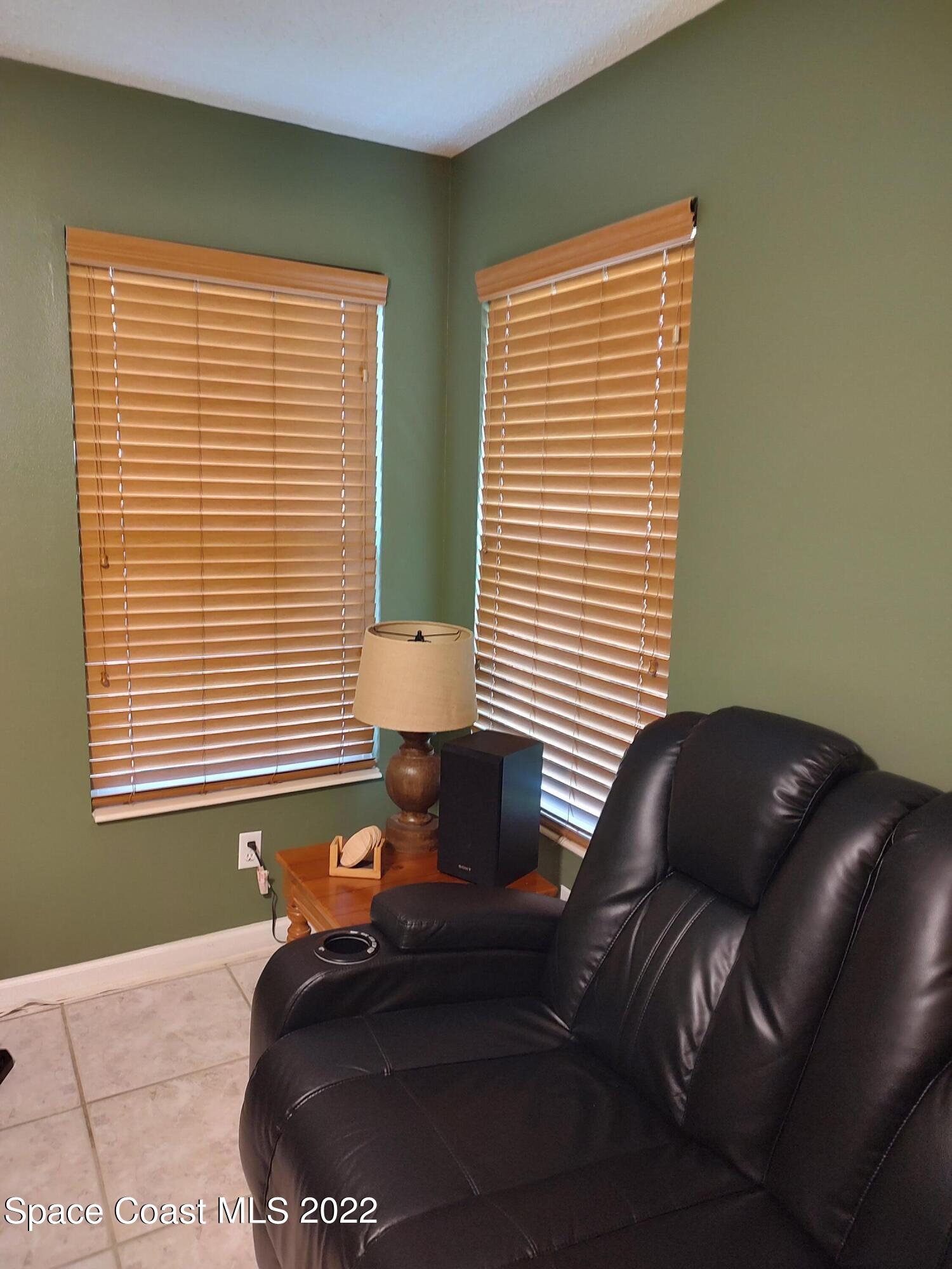 1233 Walnut Grove Way Rockledge, FL 32955 - Photo 11 of 19 a bedroom with a bed and a window