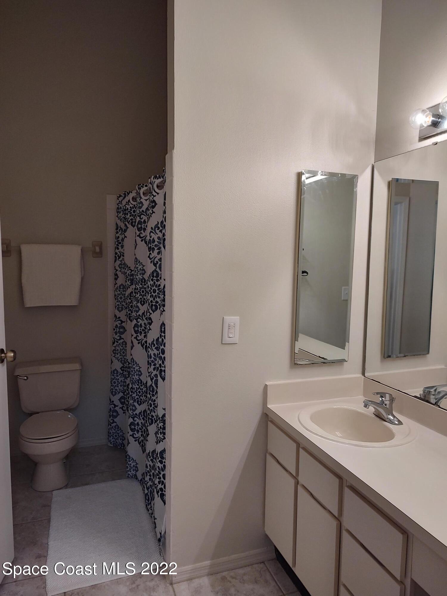 1233 Walnut Grove Way Rockledge, FL 32955 - Photo 13 of 19 a bathroom with a sink toilet and shower
