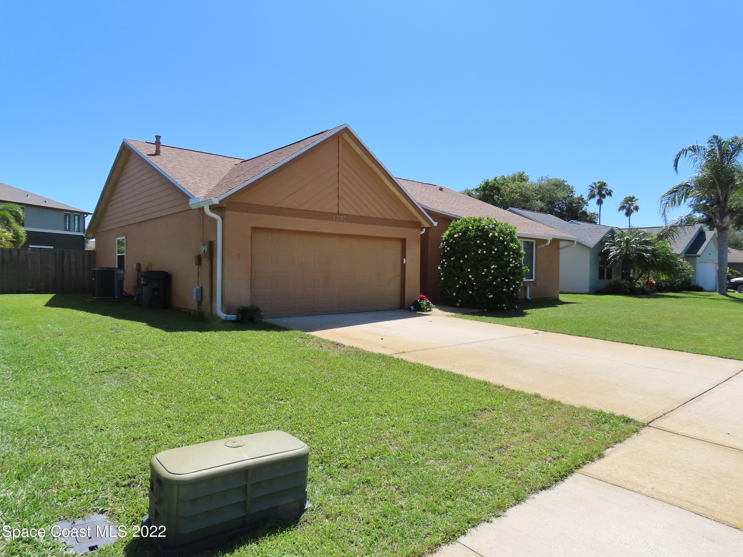 1233 Walnut Grove Way Rockledge, FL 32955 - Photo 2 of 19 a backyard of a house with lots of green space