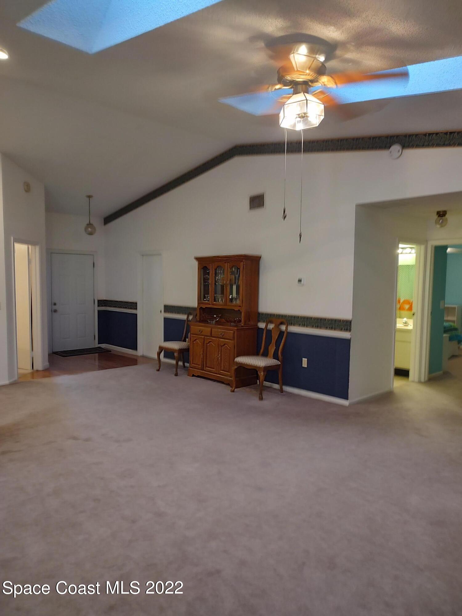 1233 Walnut Grove Way Rockledge, FL 32955 - Photo 4 of 19 a view of a livingroom with furniture and a flat screen tv