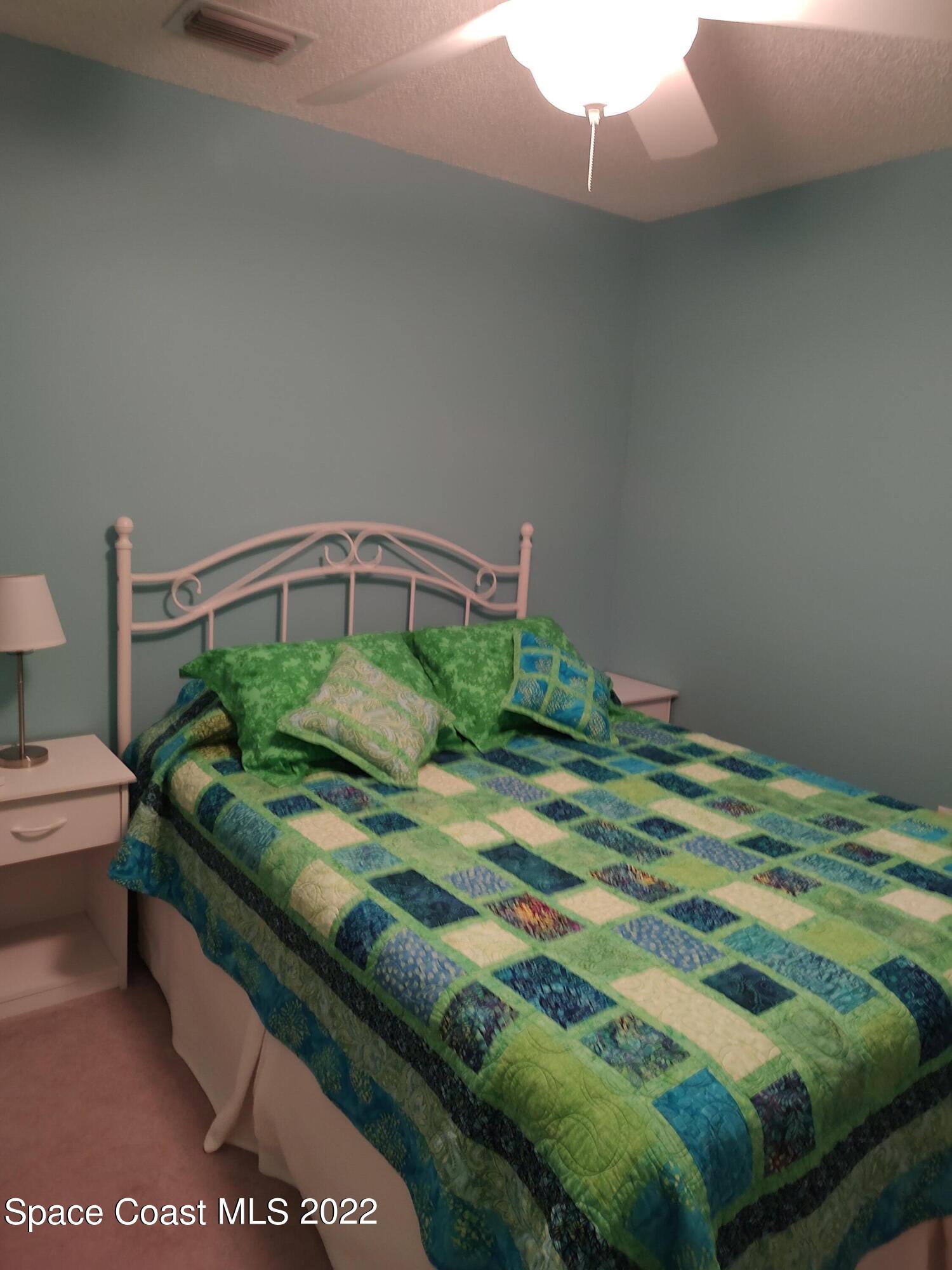 1233 Walnut Grove Way Rockledge, FL 32955 - Photo 8 of 19 a bedroom with a bed and a window