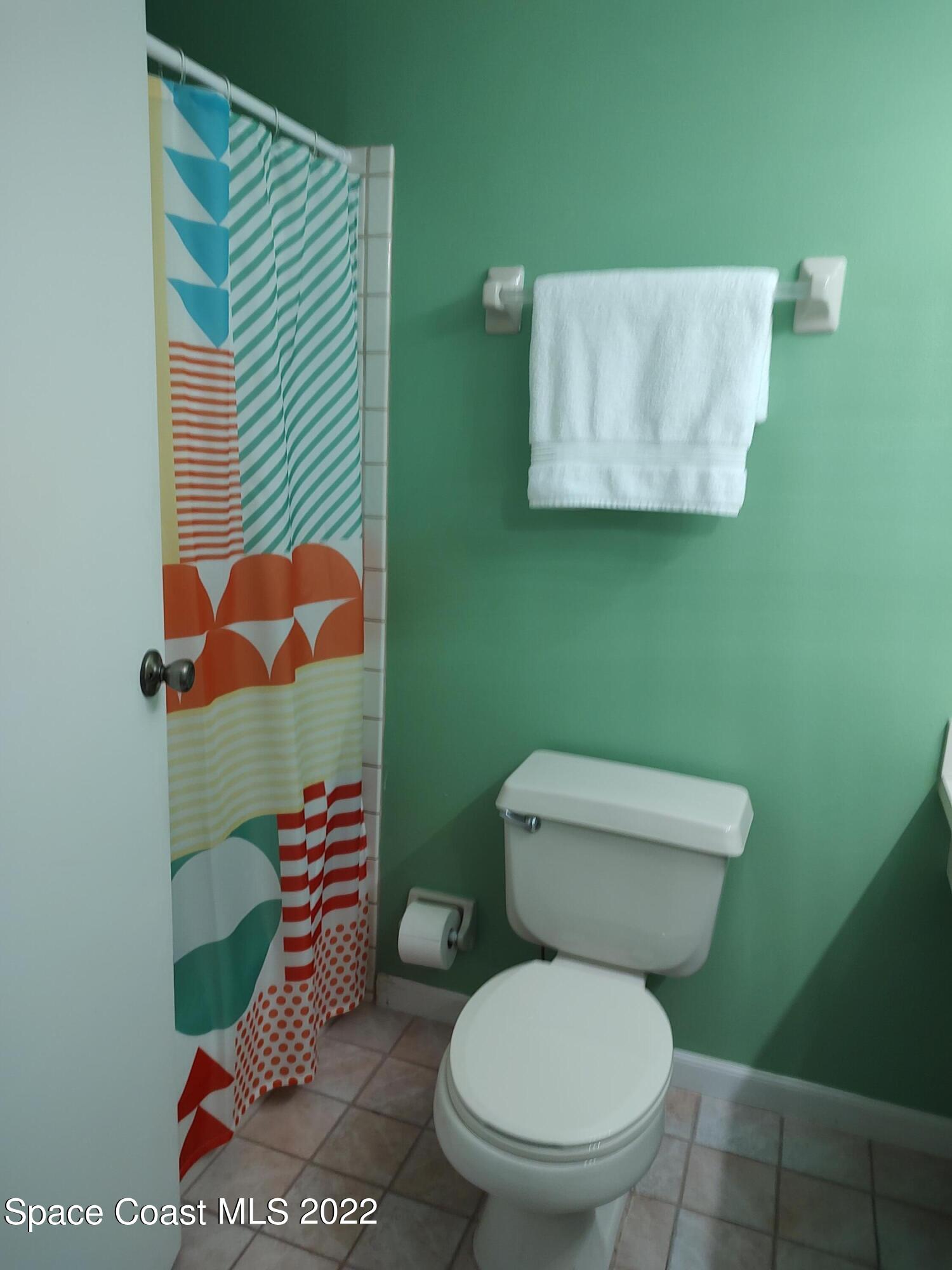 1233 Walnut Grove Way Rockledge, FL 32955 - Photo 9 of 19 a white toilet sitting next to a bathroom sink