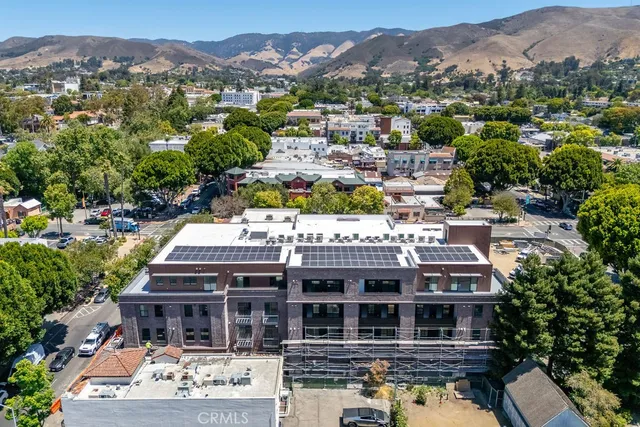 an aerial view of residential houses and lake view