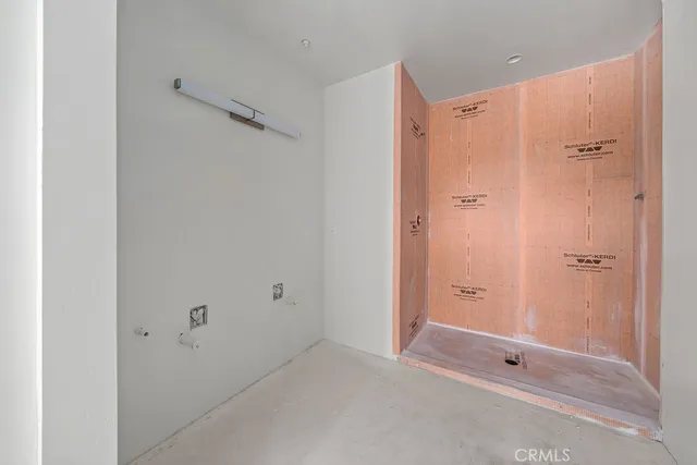 a bathroom with a shower and a glass door