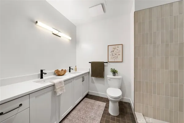 a bathroom with a toilet a sink and mirror