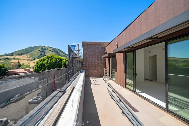 a view of balcony with floor to ceiling windows with wooden floor