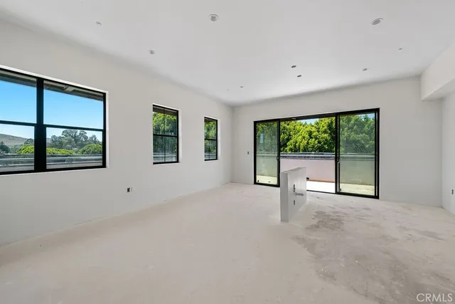 a view of a house with a yard and potted plants