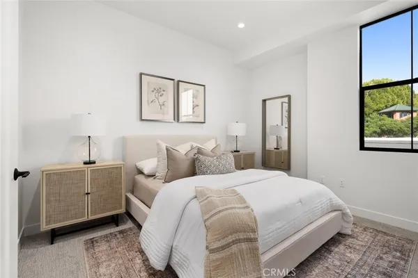 a spacious bedroom with a bed and a window