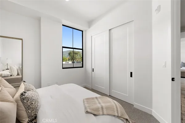 a bedroom with a bed and a couch