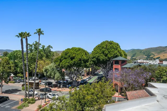 a bedroom with a large bed and a flat tv screen
