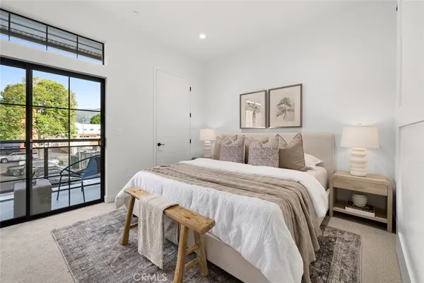 a bedroom with a bed and a large window