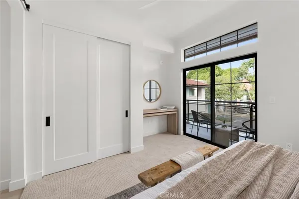 a bedroom with a bed and a large window
