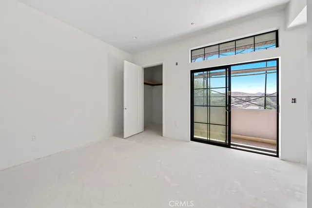 a view of an empty room with glass door