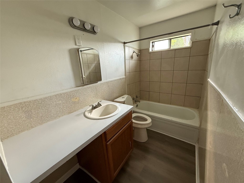 501 Houston Street Killeen, TX 76541 - Photo 3 of 11 a bathroom with a sink a toilet a mirror and bathtub