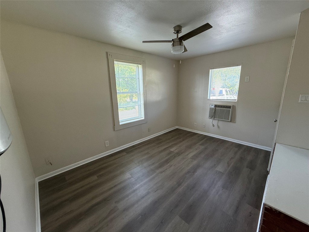 501 Houston Street Killeen, TX 76541 - Photo 5 of 11 a view of an empty room with a window and wooden floor