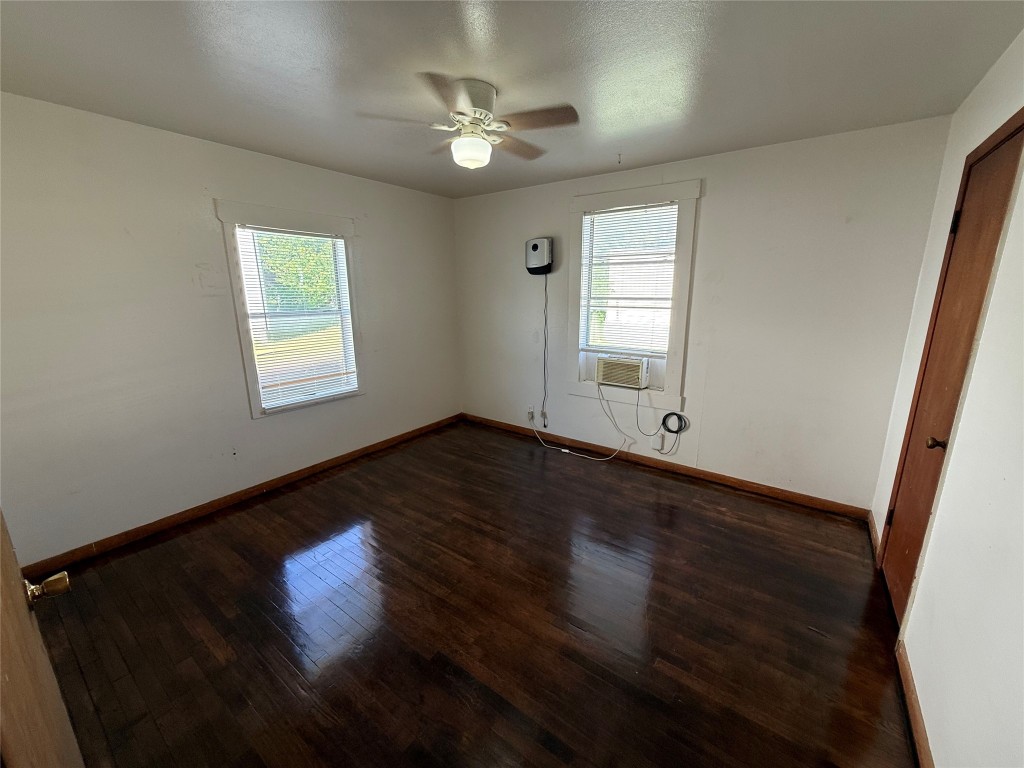501 Houston Street Killeen, TX 76541 - Photo 7 of 11 an empty room with wooden floor and windows
