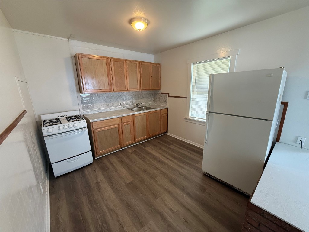501 Houston Street Killeen, TX 76541 - Photo 9 of 11 a kitchen with stainless steel appliances granite countertop a refrigerator a stove a sink and a microwave