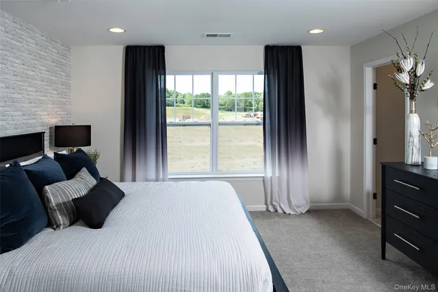 a bedroom with a bed and large window