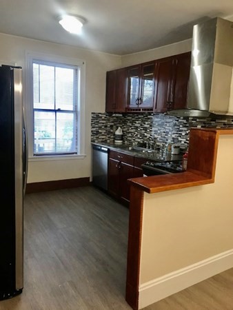20 Bennett Street Beverly, MA 01915 - Photo 15 of 20 a kitchen with a stove and a window