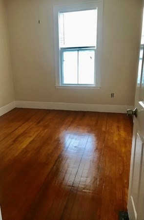 20 Bennett Street Beverly, MA 01915 - Photo 16 of 20 an empty room with wooden floor and windows