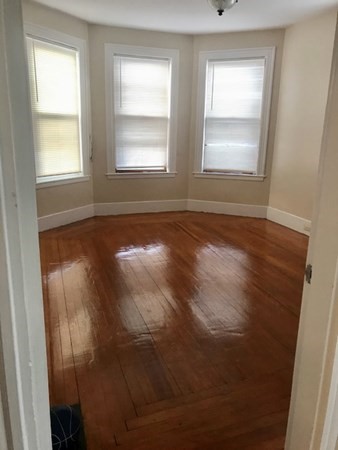 20 Bennett Street Beverly, MA 01915 - Photo 18 of 20 an empty room with wooden floor and windows