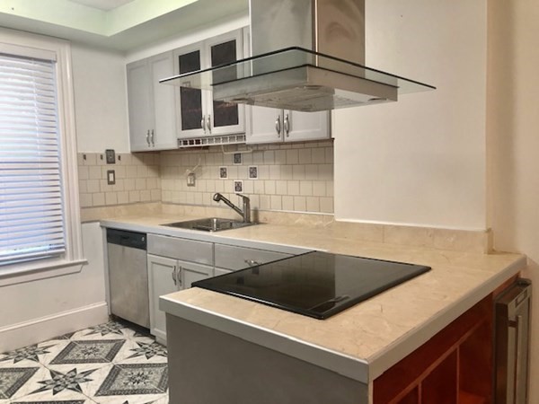 20 Bennett Street Beverly, MA 01915 - Photo 4 of 20 a kitchen that has a sink and a stove in it