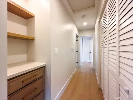 a view of a hallway with wooden floor