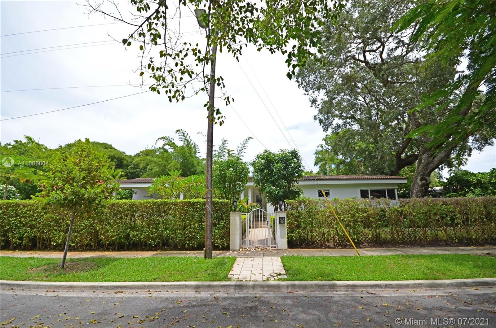 175 Southwest 24th Road Miami, FL 33129 - Photo 2 of 17 a front view of a house with a yard and garage