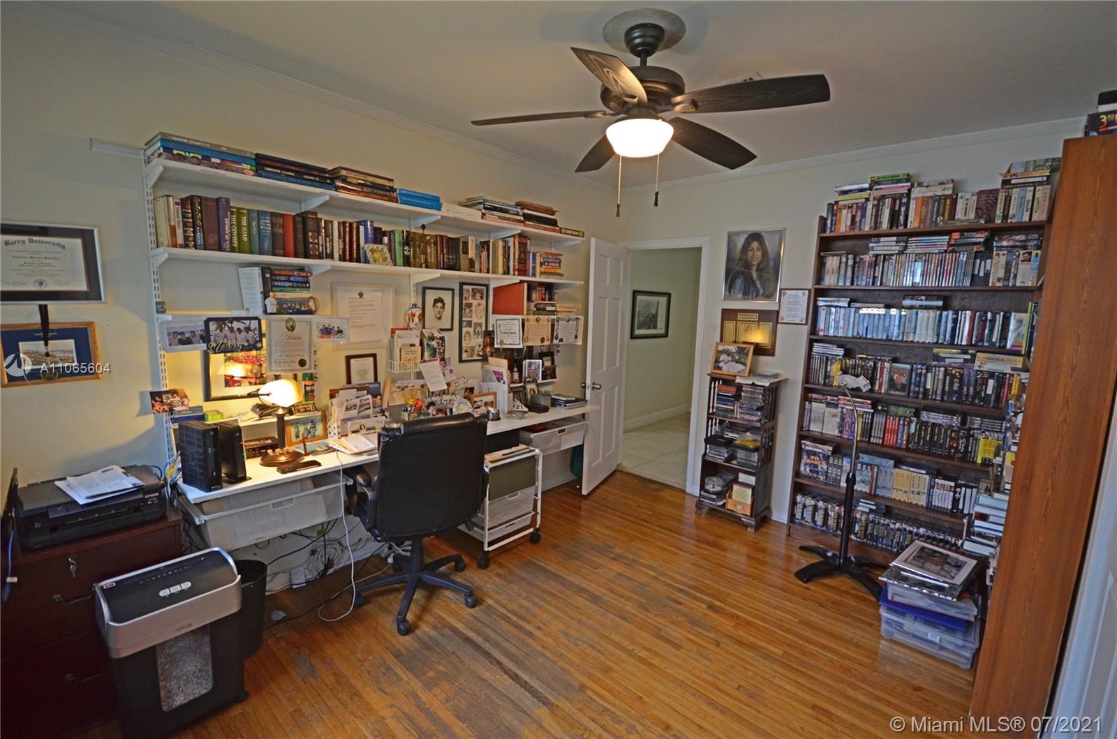 175 Southwest 24th Road Miami, FL 33129 - Photo 12 of 17 a view of a workspace with furniture bookshelf and a window