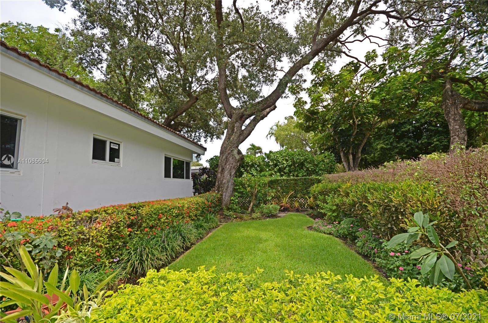 175 Southwest 24th Road Miami, FL 33129 - Photo 3 of 17 a view of a backyard with large trees