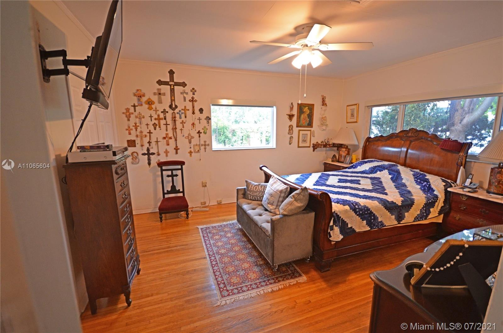 175 Southwest 24th Road Miami, FL 33129 - Photo 5 of 17 a bedroom with furniture and a wooden floor