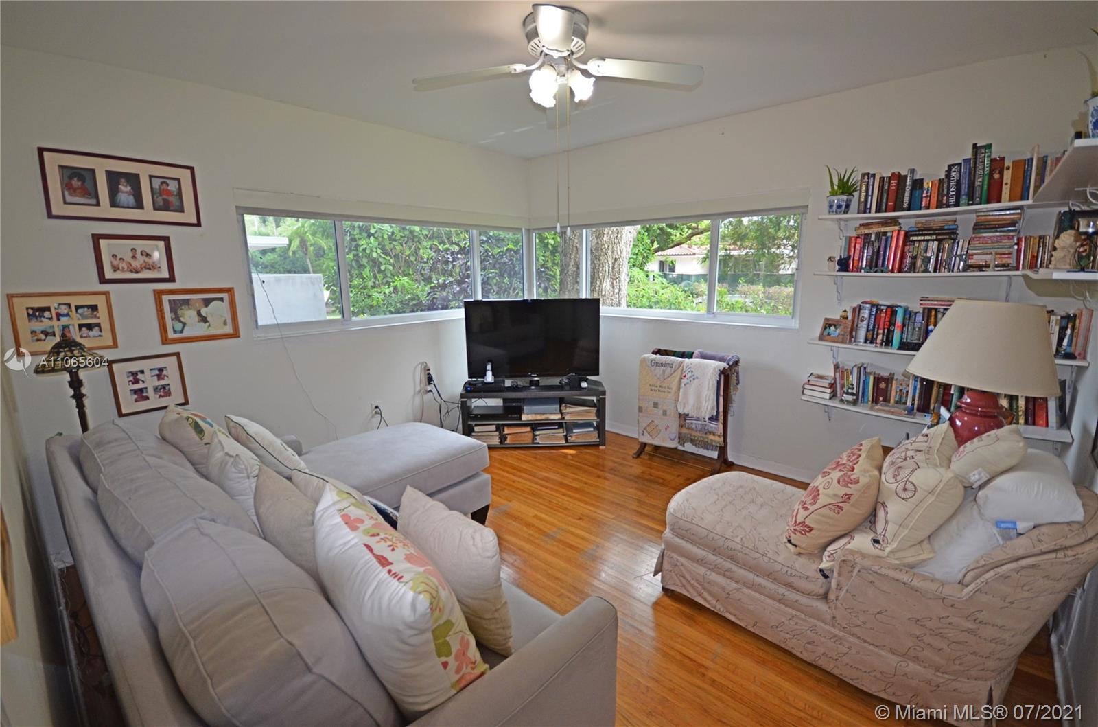 175 Southwest 24th Road Miami, FL 33129 - Photo 7 of 17 a living room with furniture and a flat screen tv