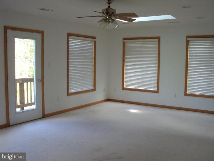 255 Mountain Top Road Front Royal, VA 22630 - Photo 11 of 30 an empty room with windows and fan