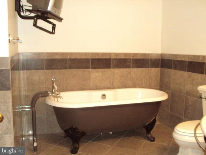 255 Mountain Top Road Front Royal, VA 22630 - Photo 19 of 30 a bathroom with a bathtub and shower