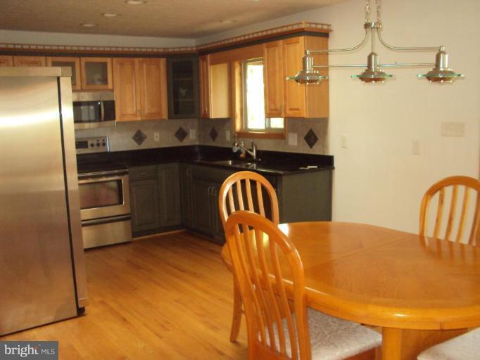 255 Mountain Top Road Front Royal, VA 22630 - Photo 9 of 30 a kitchen with stainless steel appliances granite countertop a sink a stove and refrigerator