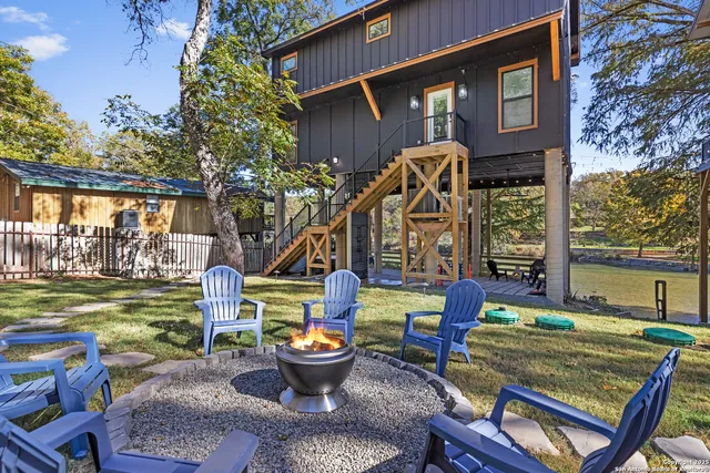 a front view of a house with garden and sitting area