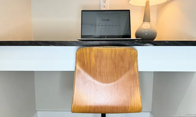 a balcony with wooden floor and yard in the back