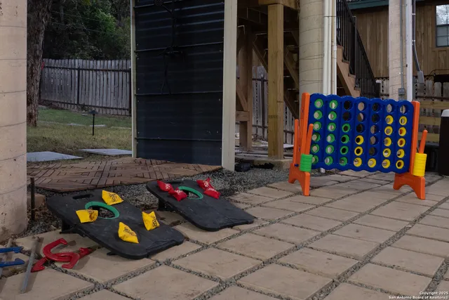 a building outdoor space with patio furniture and potted plants