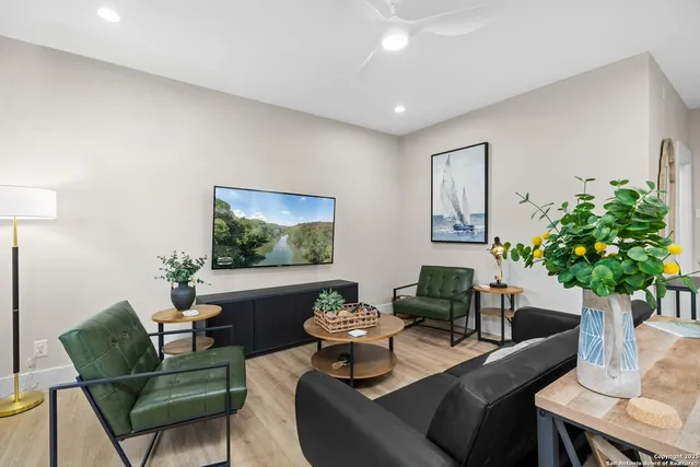 a living room with furniture potted plant and a lamp