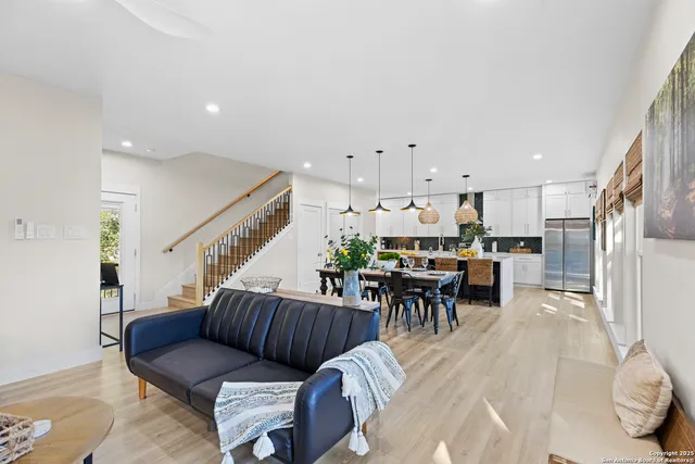 a living room with furniture kitchen view and a dining table